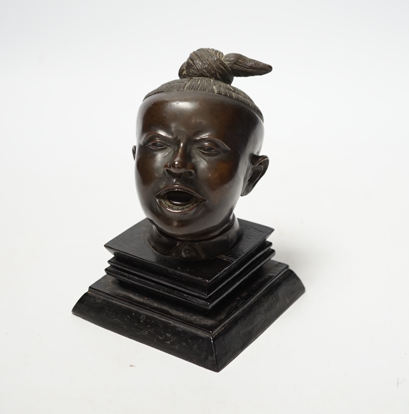 A Malaysian bronze head of a boy, 12.5cm high